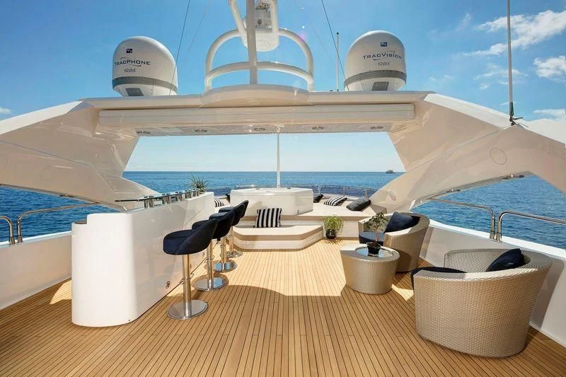 a deck with a large white pool and a large white building with a white dome and a white aboard THE DEVOCEAN Yacht for Sale