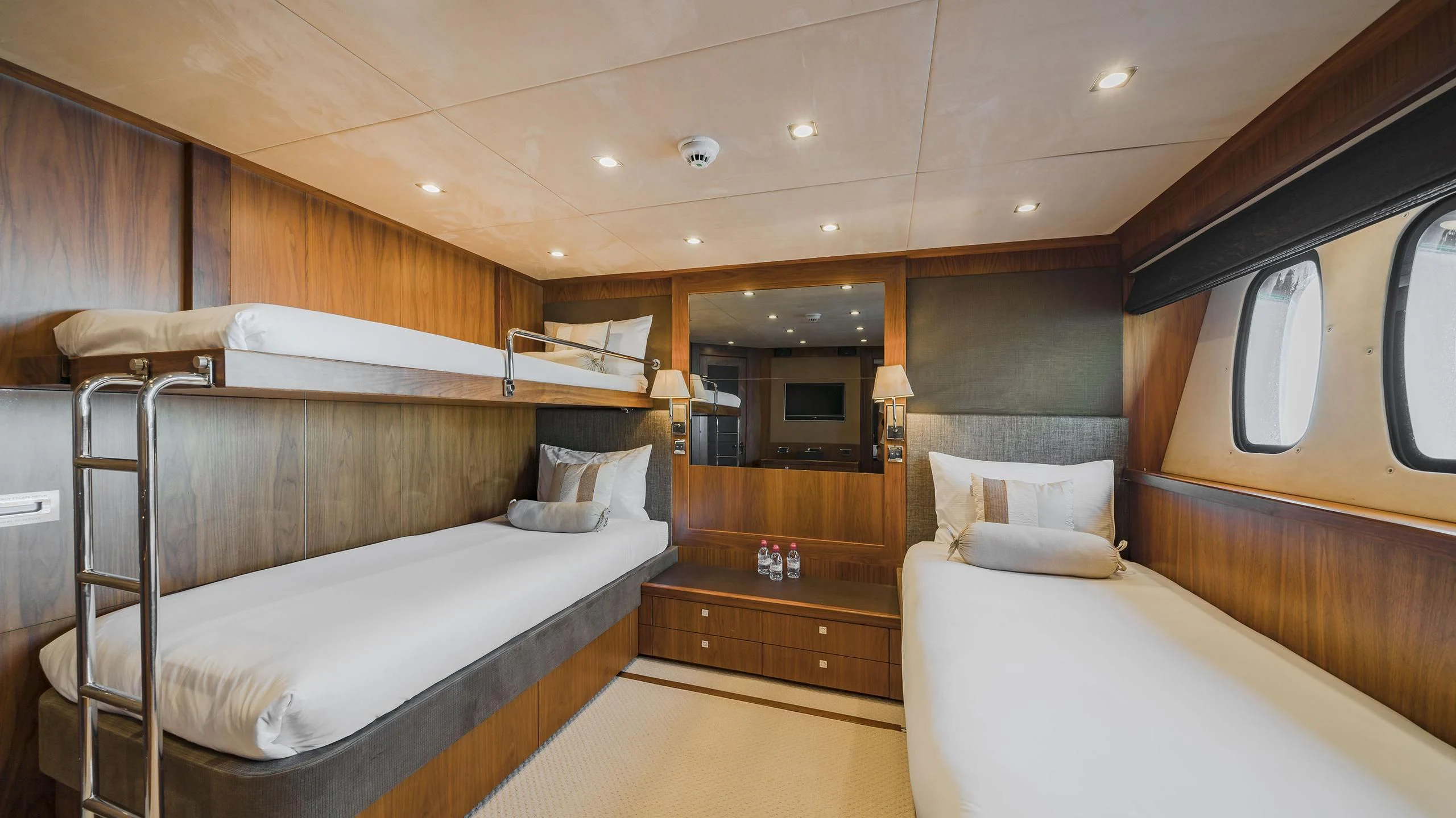 a room with a bed and a mirror aboard THE DEVOCEAN Yacht for Sale