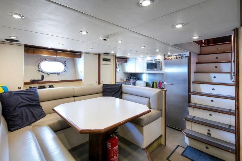 a small kitchen with a table aboard THE DEVOCEAN Yacht for Sale