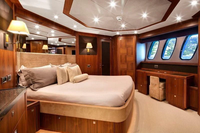 a room with a bed and a tv aboard THE DEVOCEAN Yacht for Sale