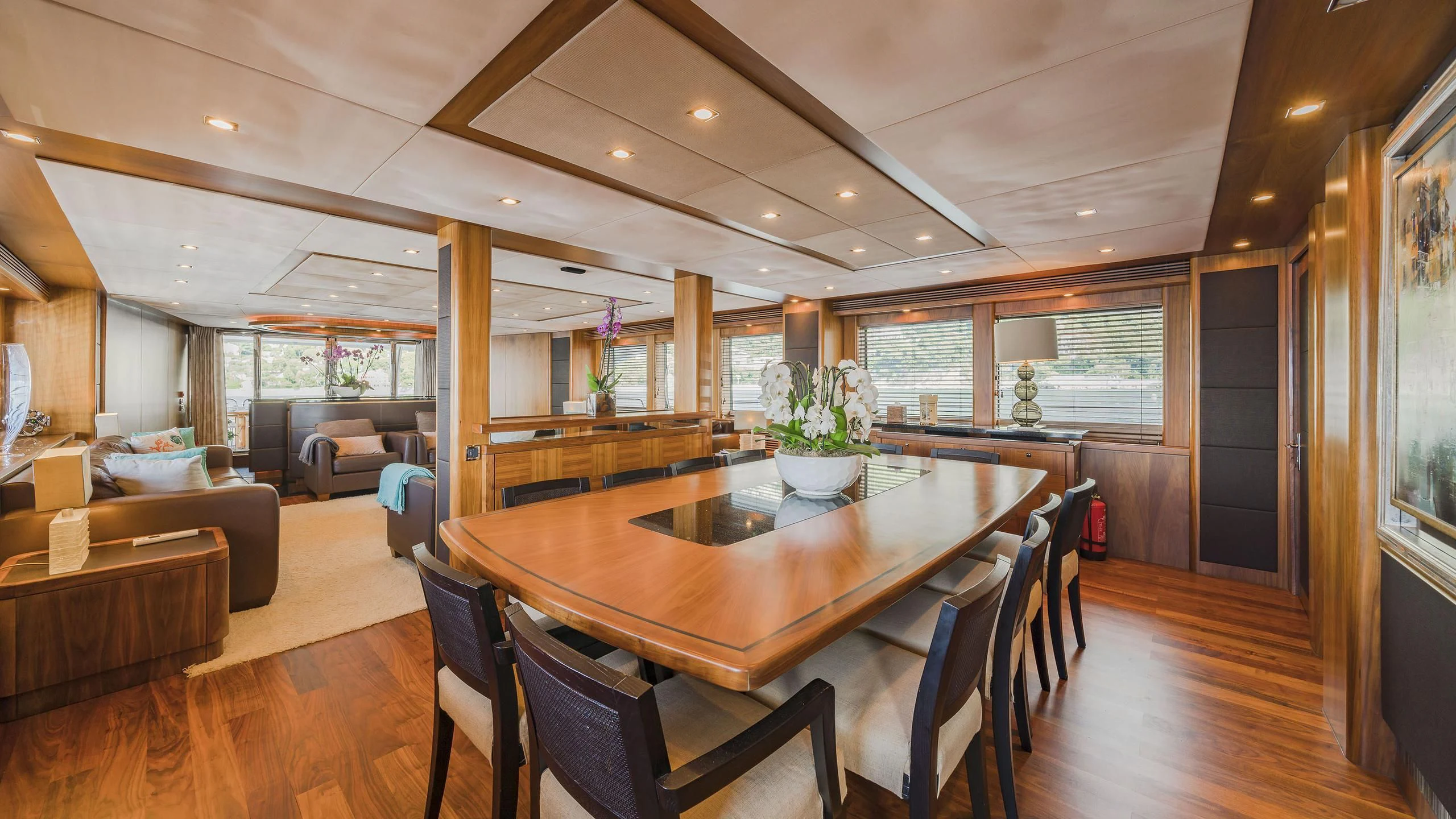 a large dining table in a living room aboard THE DEVOCEAN Yacht for Sale