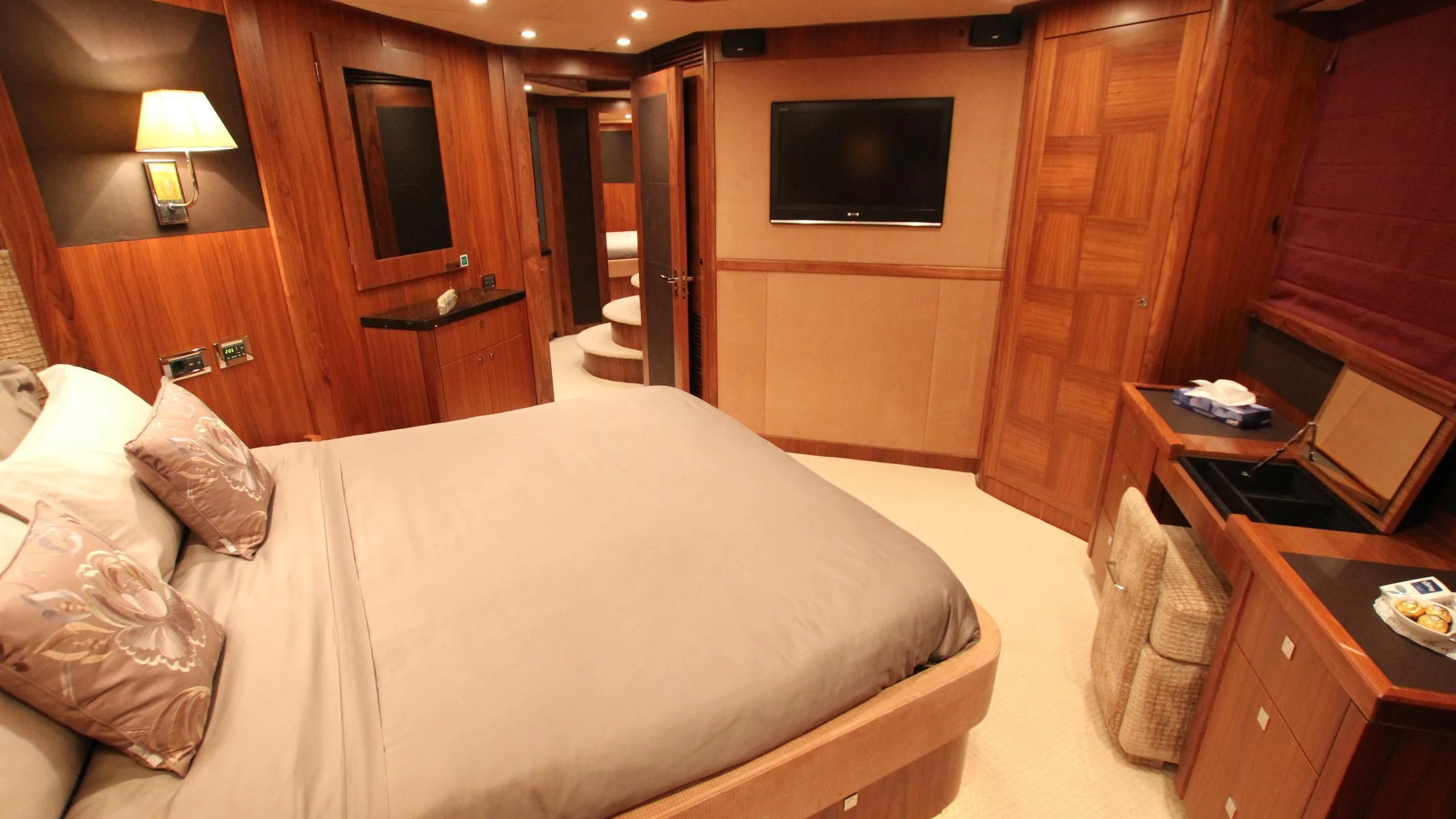 a hotel room with a bed and tv aboard THE DEVOCEAN Yacht for Sale