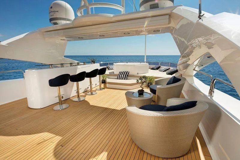 a room with a table and chairs aboard THE DEVOCEAN Yacht for Sale