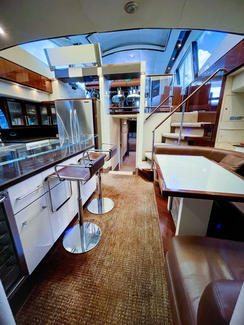 a kitchen with a bar and a staircase aboard LOVIN LIFE Yacht for Sale