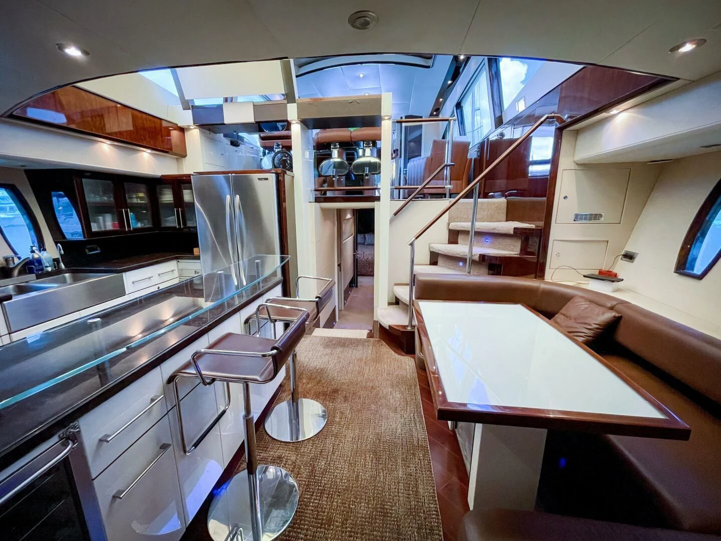 a kitchen with a dining table and a staircase aboard LOVIN LIFE Yacht for Sale