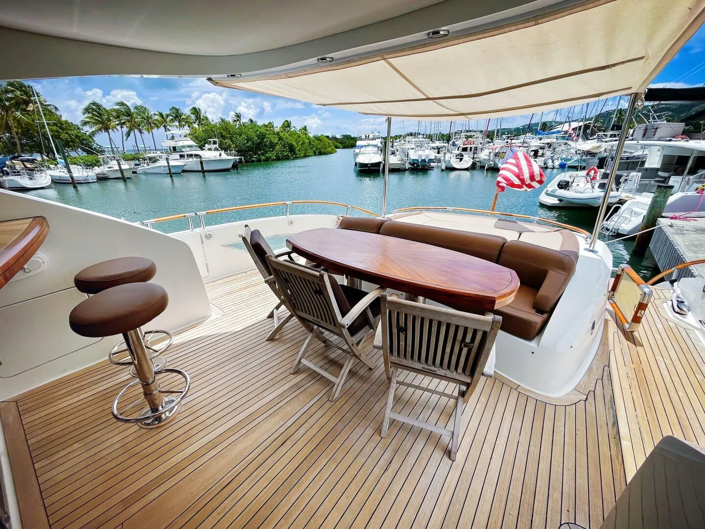 a table and chairs on a deck overlooking a body of water aboard LOVIN LIFE Yacht for Sale