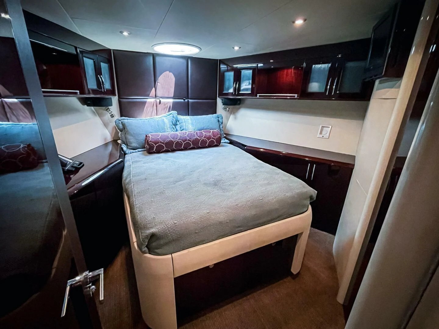 a room with a bed and a mirror aboard LOVIN LIFE Yacht for Sale