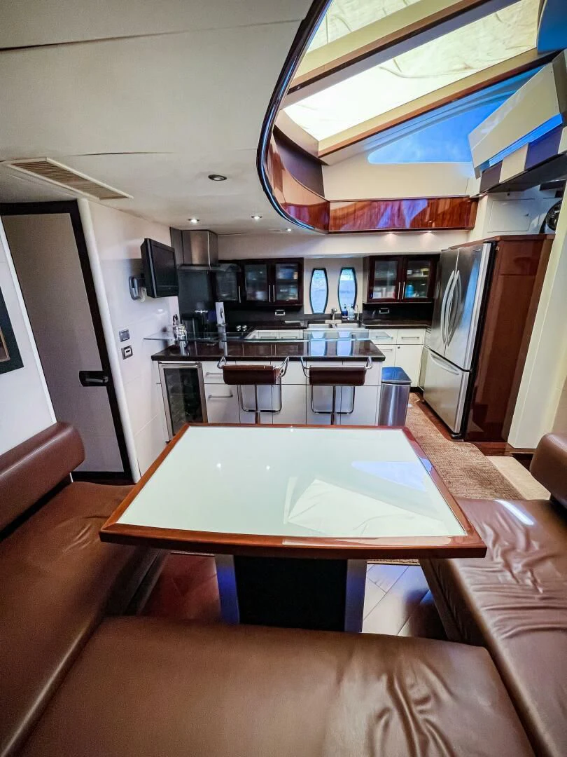a kitchen with a table and chairs aboard LOVIN LIFE Yacht for Sale