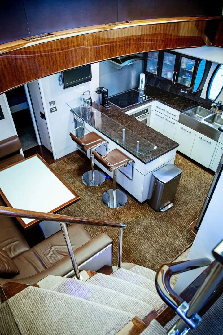 a kitchen with a bar and stools aboard LOVIN LIFE Yacht for Sale