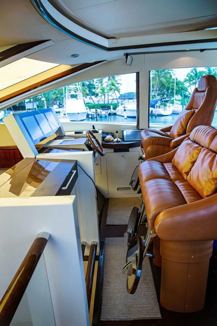 a room with a couch and a desk with a laptop on it aboard LOVIN LIFE Yacht for Sale