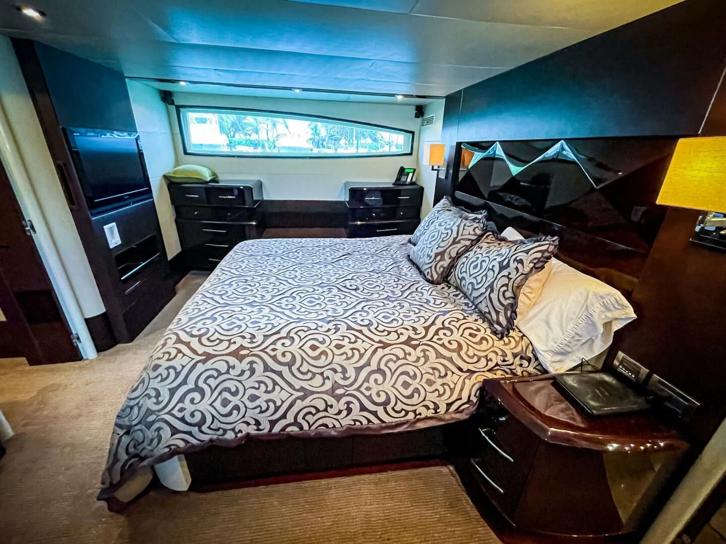 a bedroom with a bed and a desk aboard LOVIN LIFE Yacht for Sale