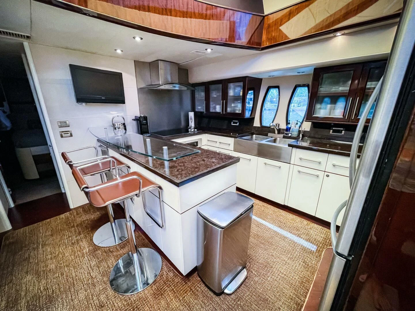 a kitchen with a bar and stools aboard LOVIN LIFE Yacht for Sale