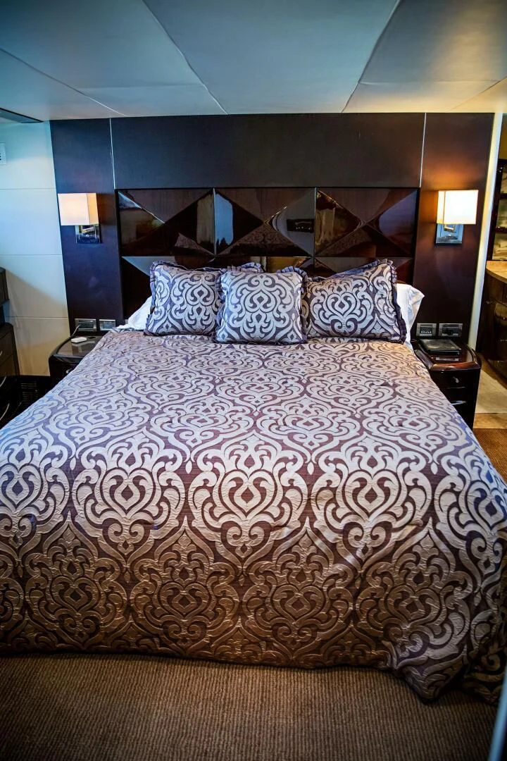 a bed with a purple comforter aboard LOVIN LIFE Yacht for Sale