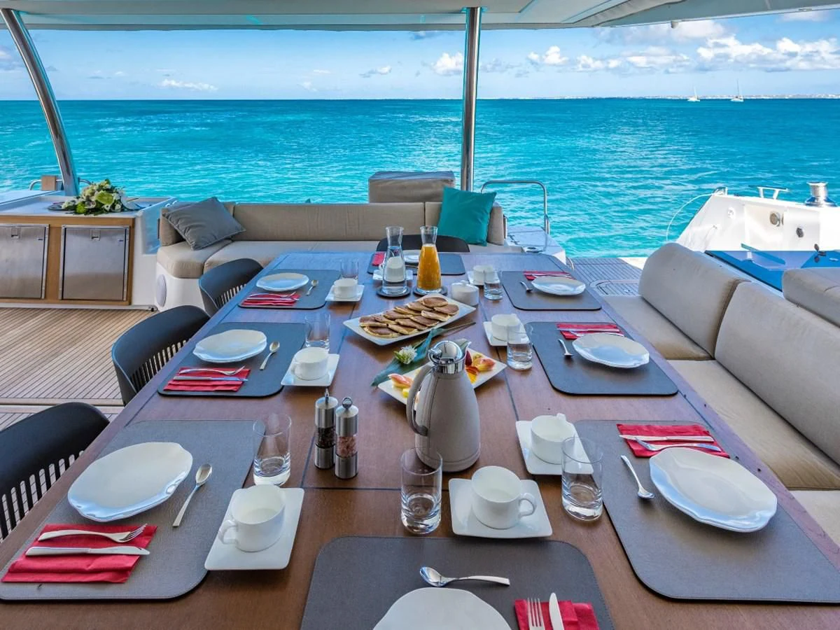 a table with plates and silverware on it aboard LISA OF THE SEAS Yacht for Sale