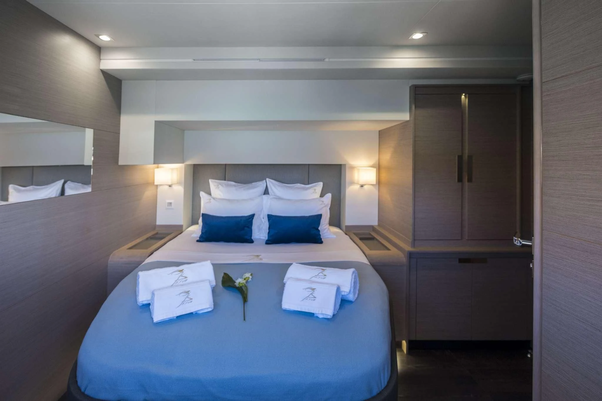 a hotel room with a bed and a desk aboard LISA OF THE SEAS Yacht for Sale