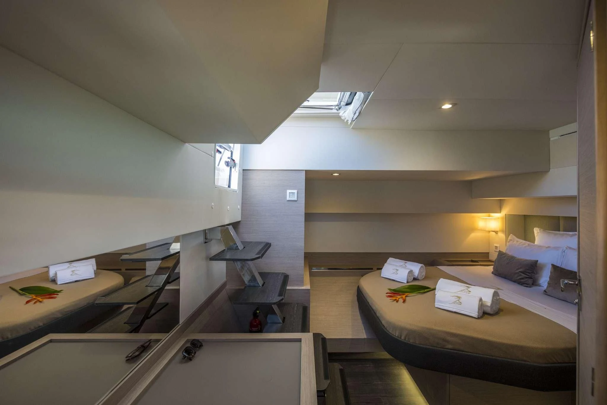 a room with a bed and desk aboard LISA OF THE SEAS Yacht for Sale