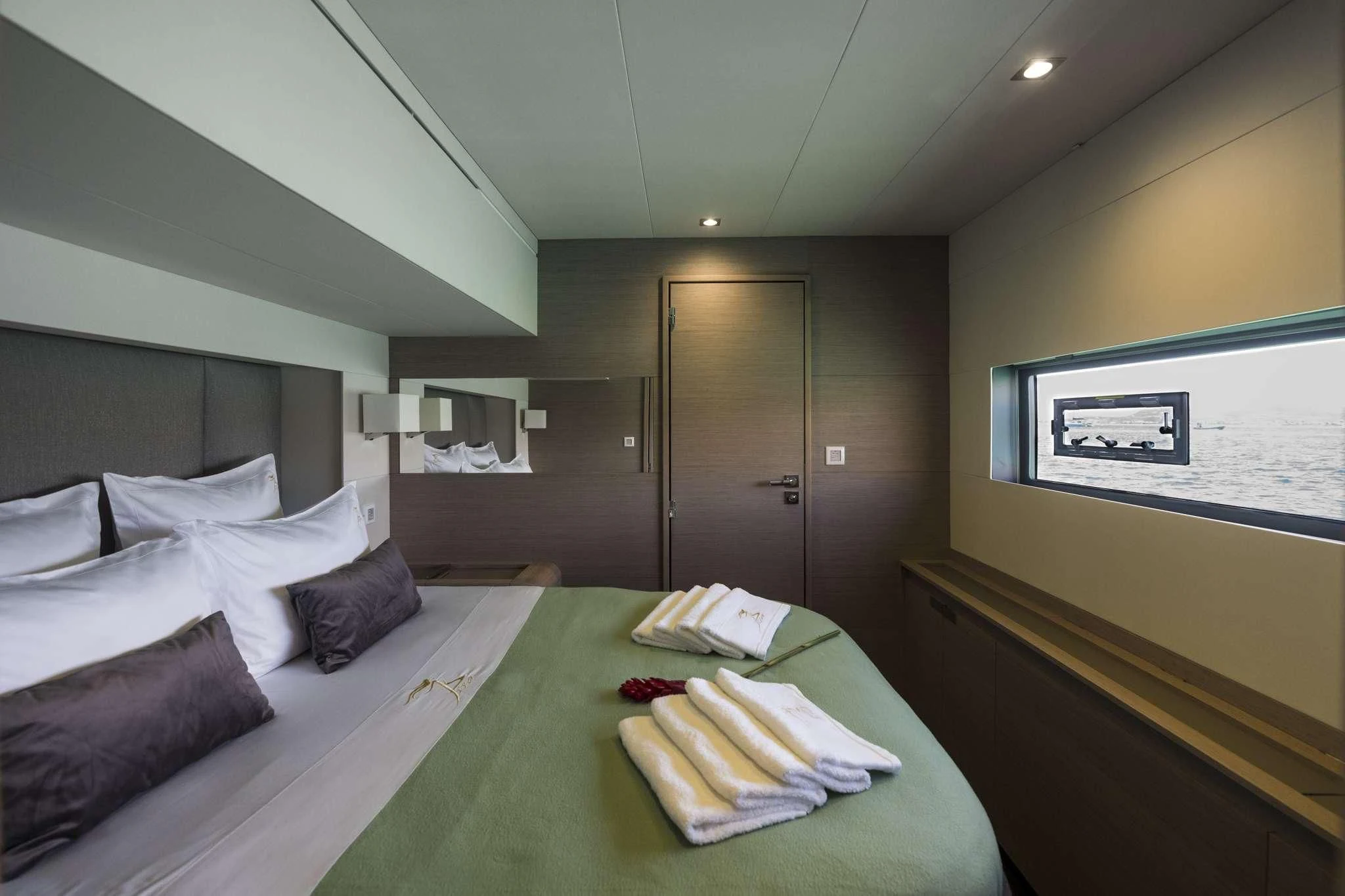 a hotel room with a bed and a table aboard LISA OF THE SEAS Yacht for Sale