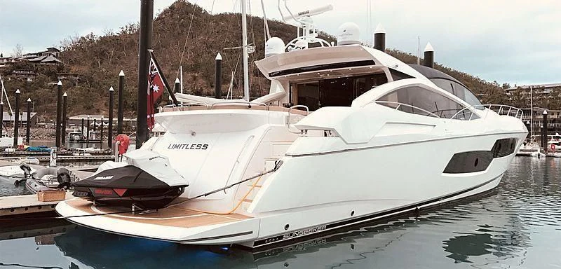 a white yacht docked aboard LIMITLESS Yacht for Sale