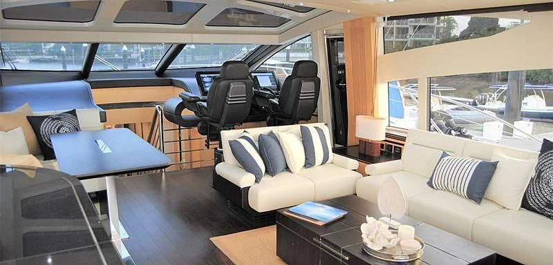 a room with a couch and a table and a window aboard LIMITLESS Yacht for Sale
