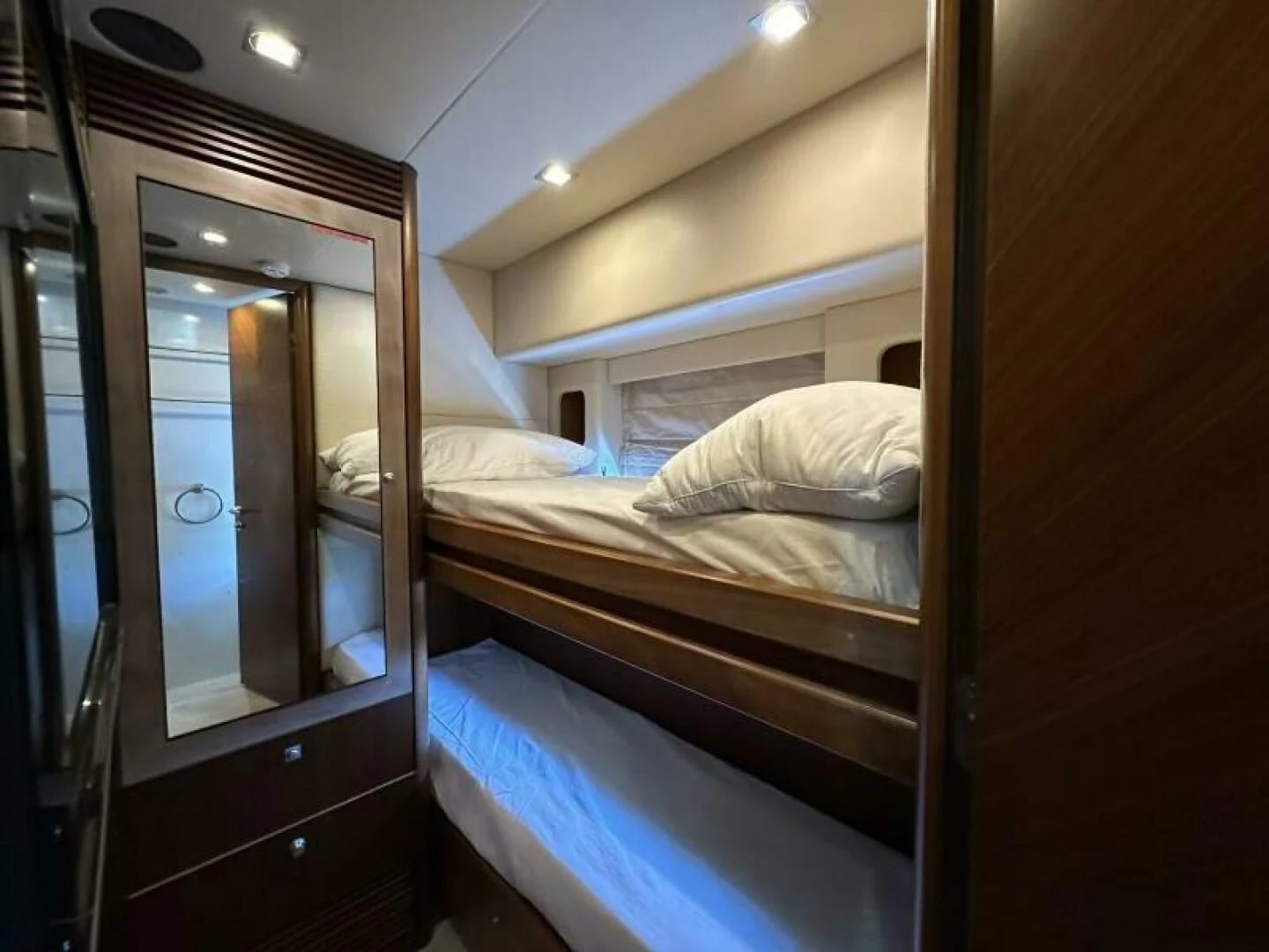 a room with a bed and a mirror aboard LOW PROFILE Yacht for Sale