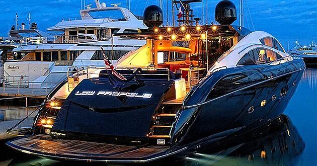 a couple of boats sit in a harbor aboard LOW PROFILE Yacht for Sale