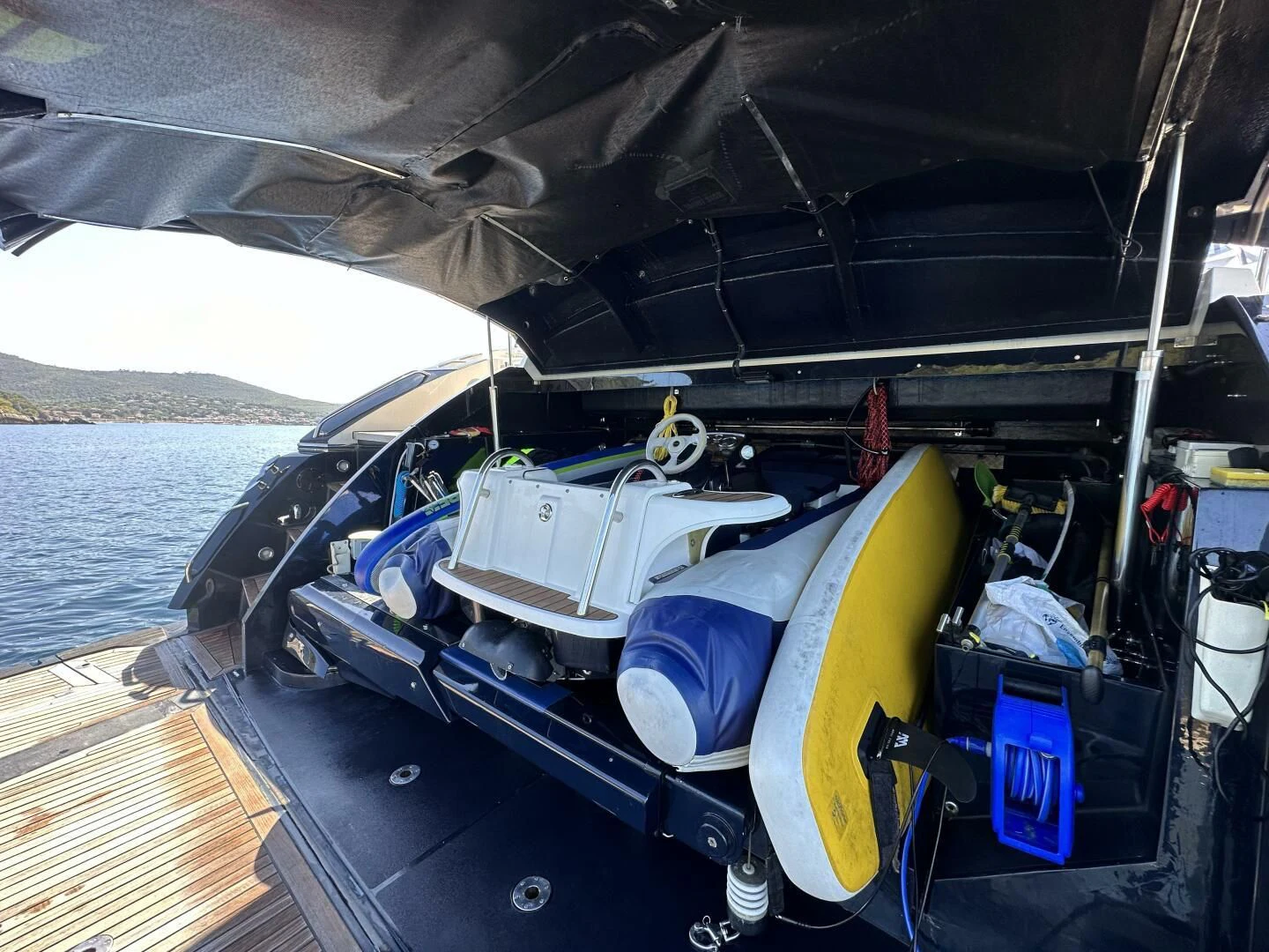 a boat with a surfboard on the deck aboard LOW PROFILE Yacht for Sale