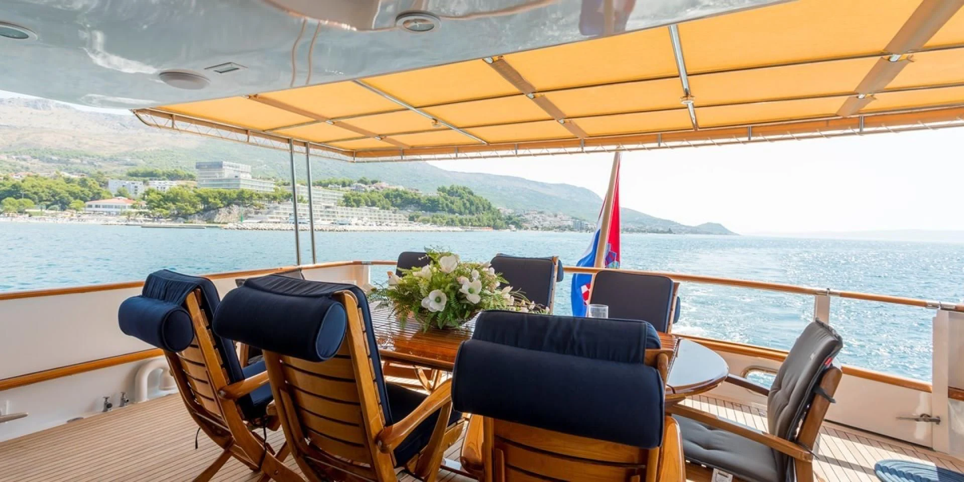 a boat with chairs and a table on the deck aboard ADRIATIC ESCAPE Yacht for Sale