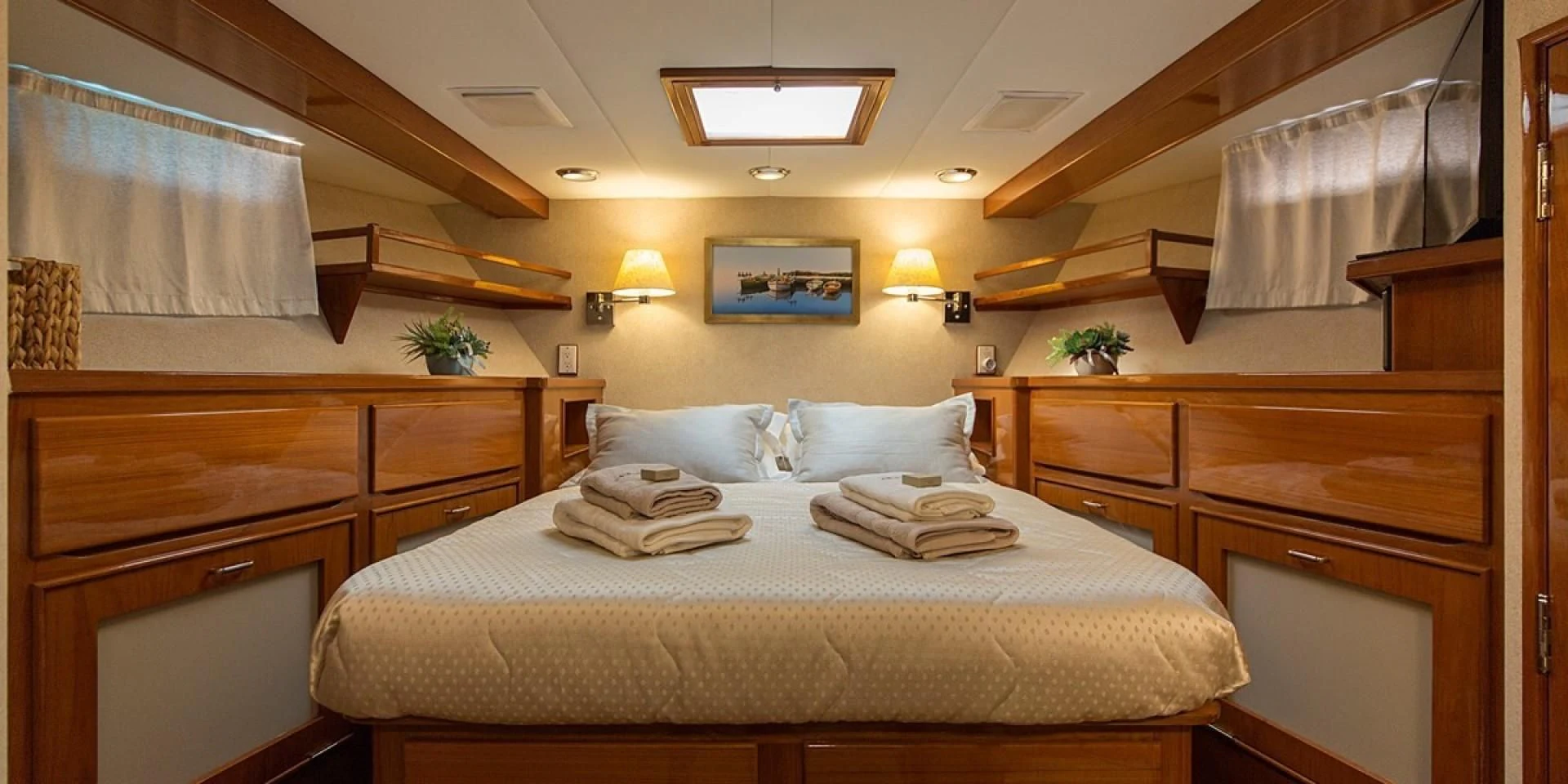 a bedroom with a bed and cabinets aboard ADRIATIC ESCAPE Yacht for Sale