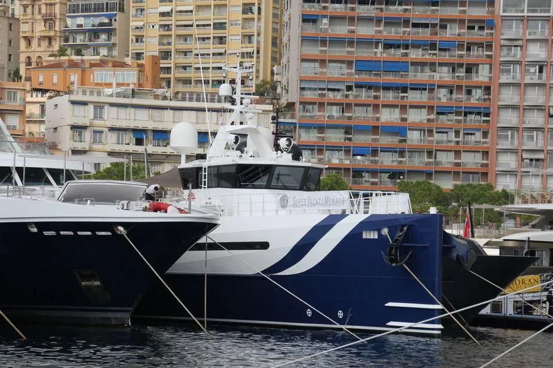 a boat docked in a harbor aboard UMBRA Yacht for Sale