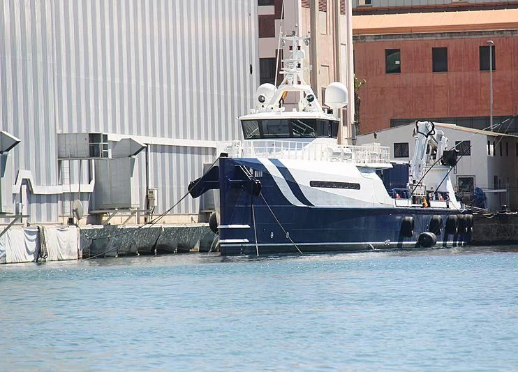 a boat docked at a pier aboard UMBRA Yacht for Sale