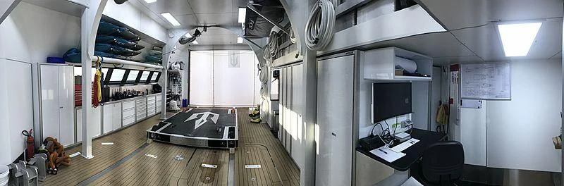 a room with a bed and desk aboard UMBRA Yacht for Sale