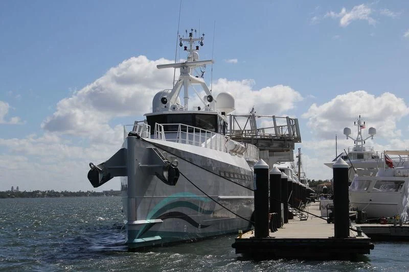 a large ship docked at a pier aboard UMBRA Yacht for Sale