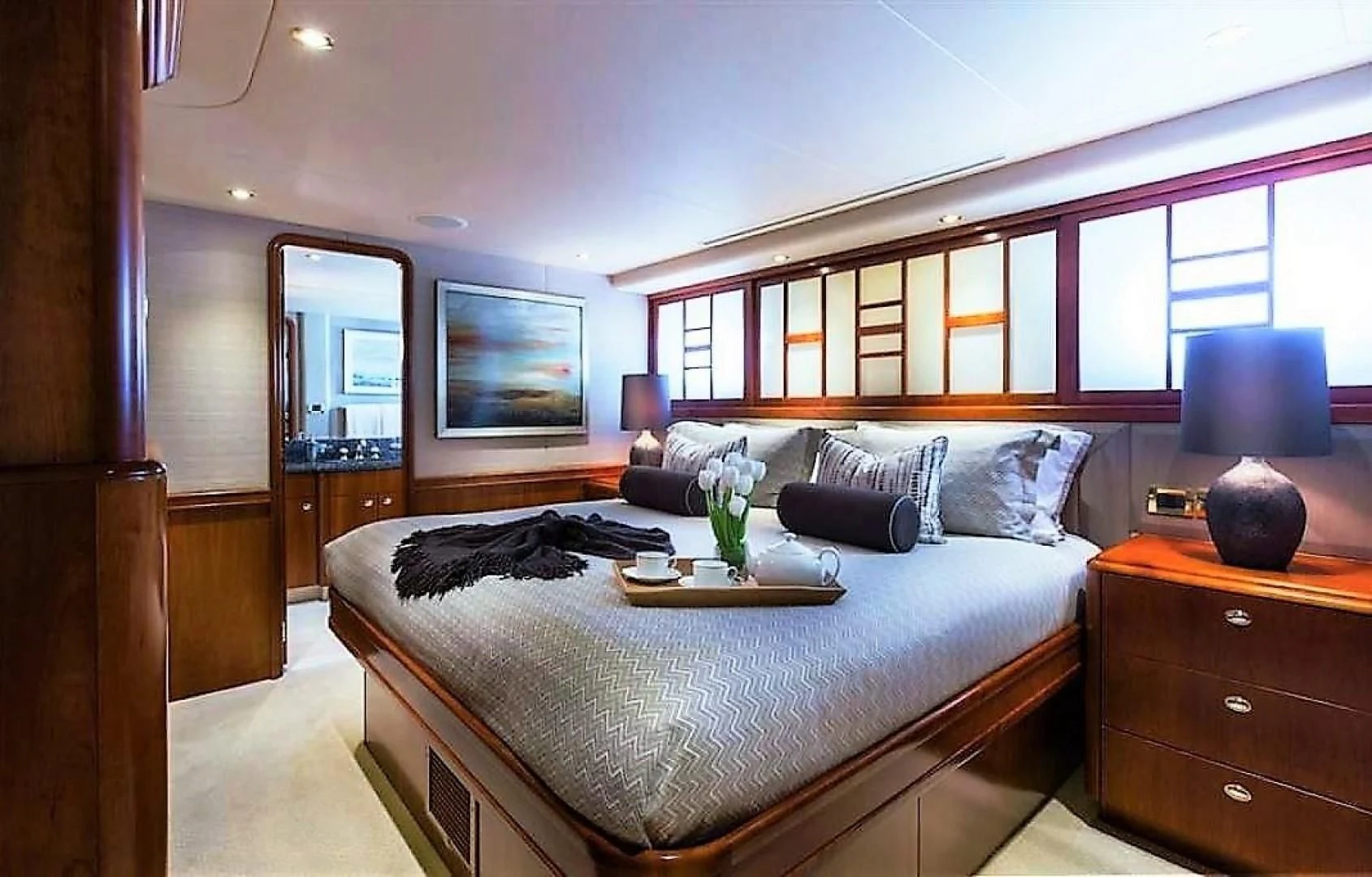 a bed with a white bed spread aboard INTUITION Yacht for Sale