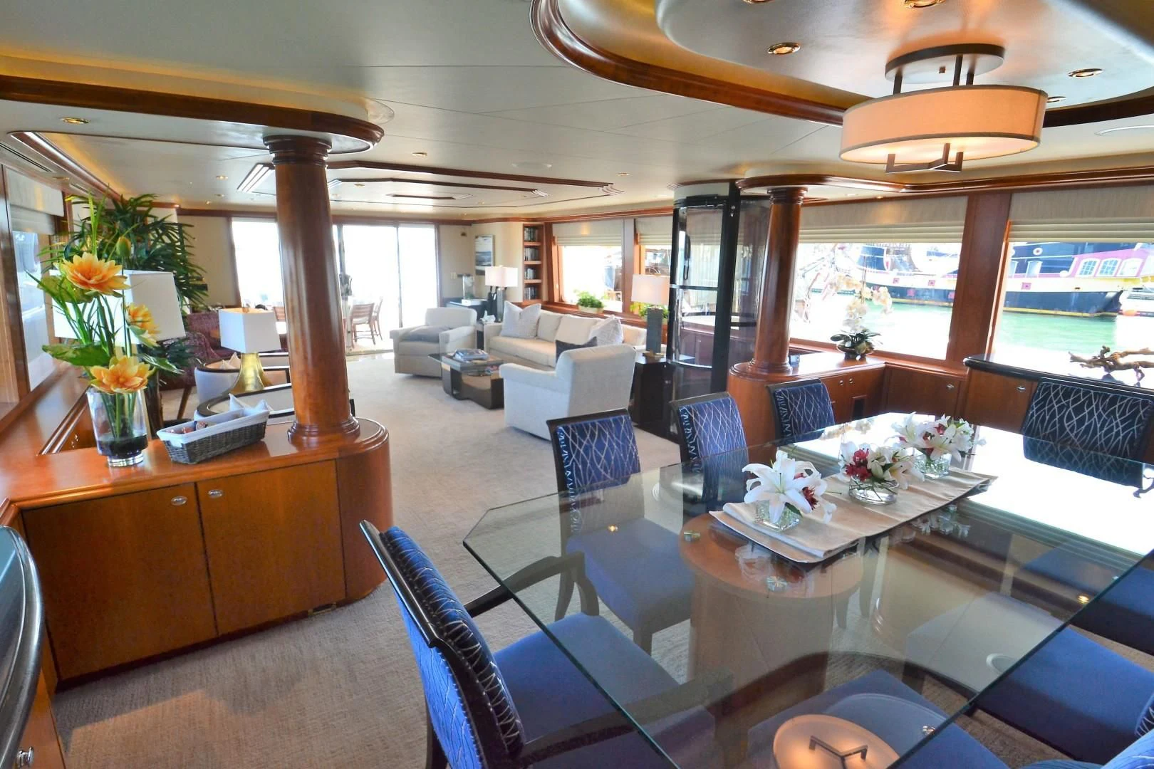 a room with a table chairs and plants aboard INTUITION Yacht for Sale