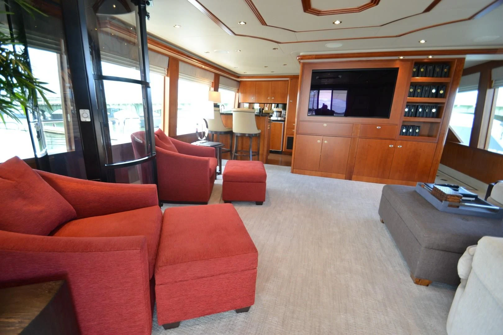 a living room with red couches aboard INTUITION Yacht for Sale