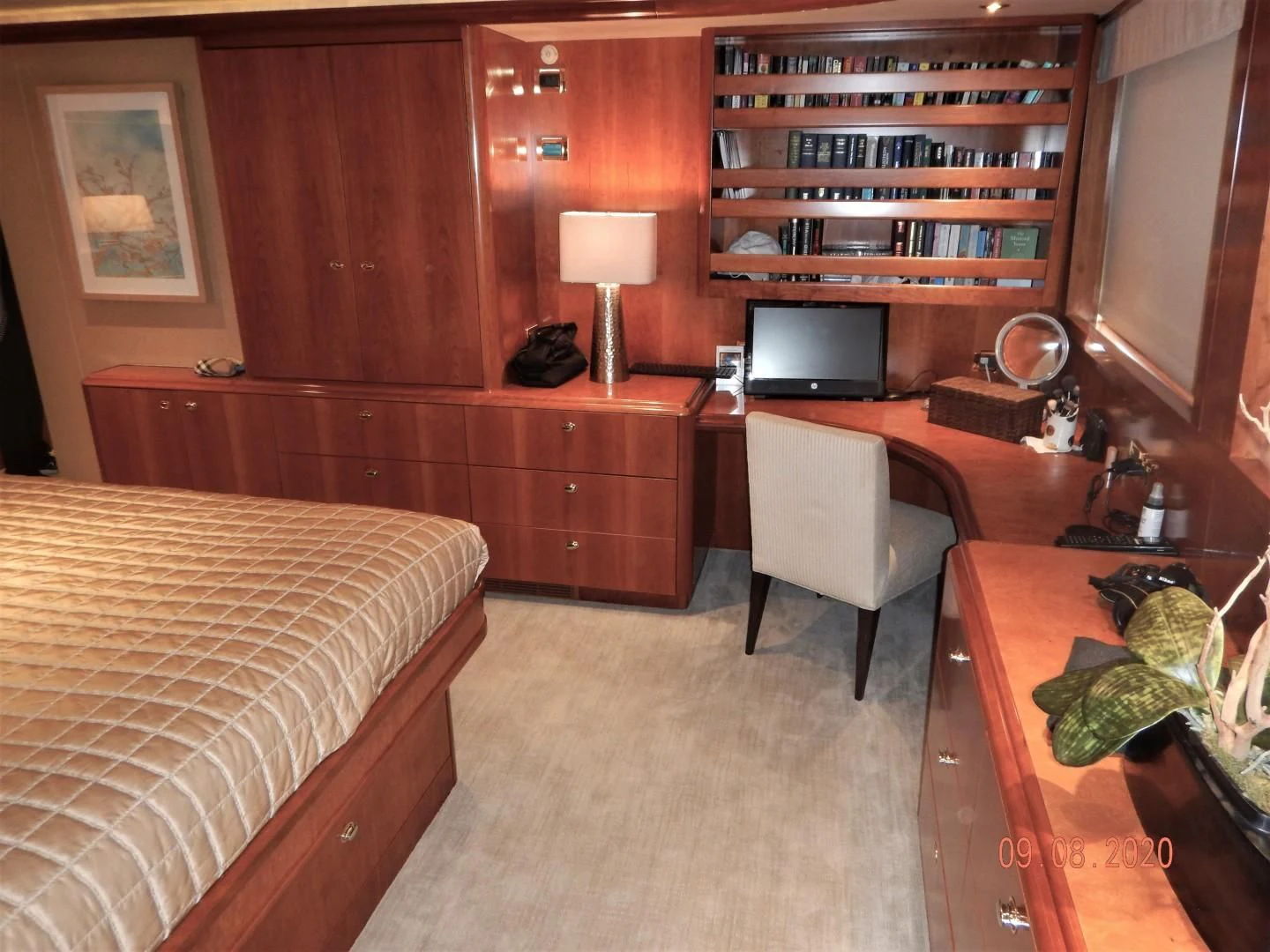 a bedroom with a bed and desk aboard INTUITION Yacht for Sale
