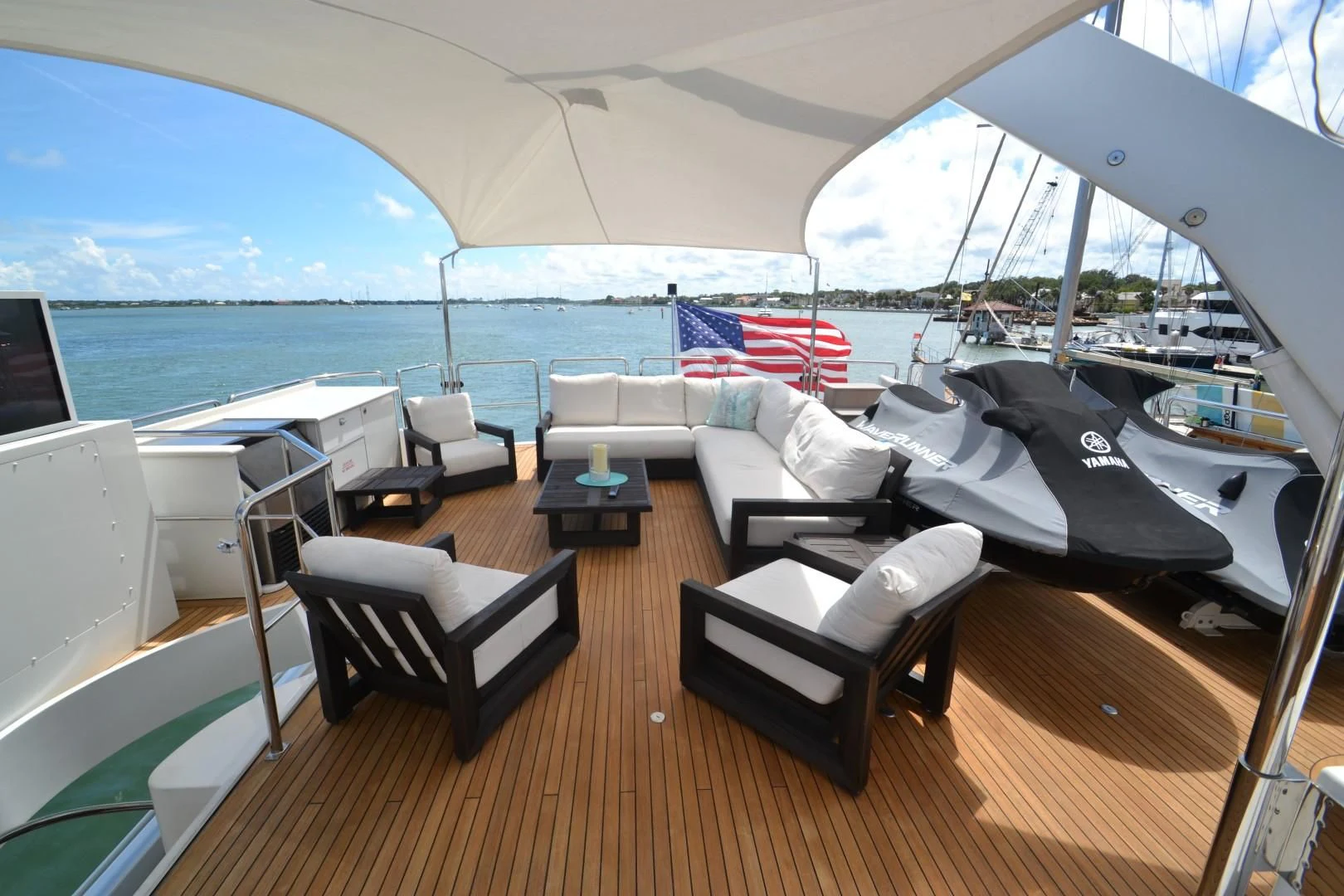 a room with a bed and a chair and a table with chairs aboard INTUITION Yacht for Sale