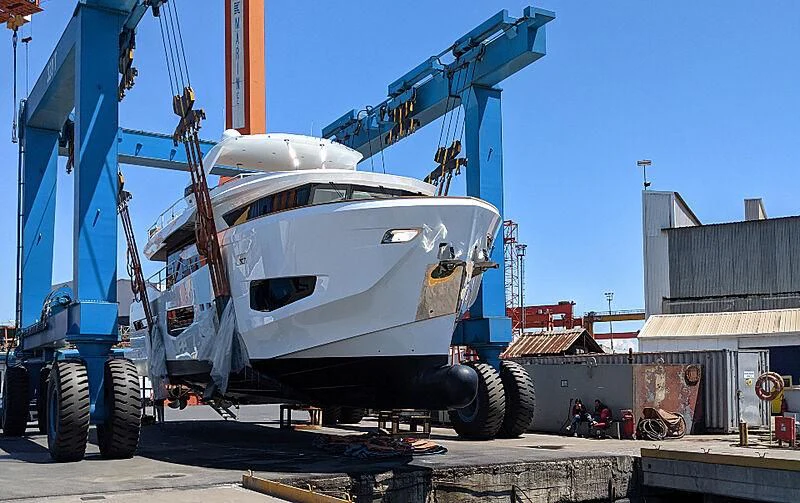 a large white boat on a trailer aboard KAI Yacht for Sale