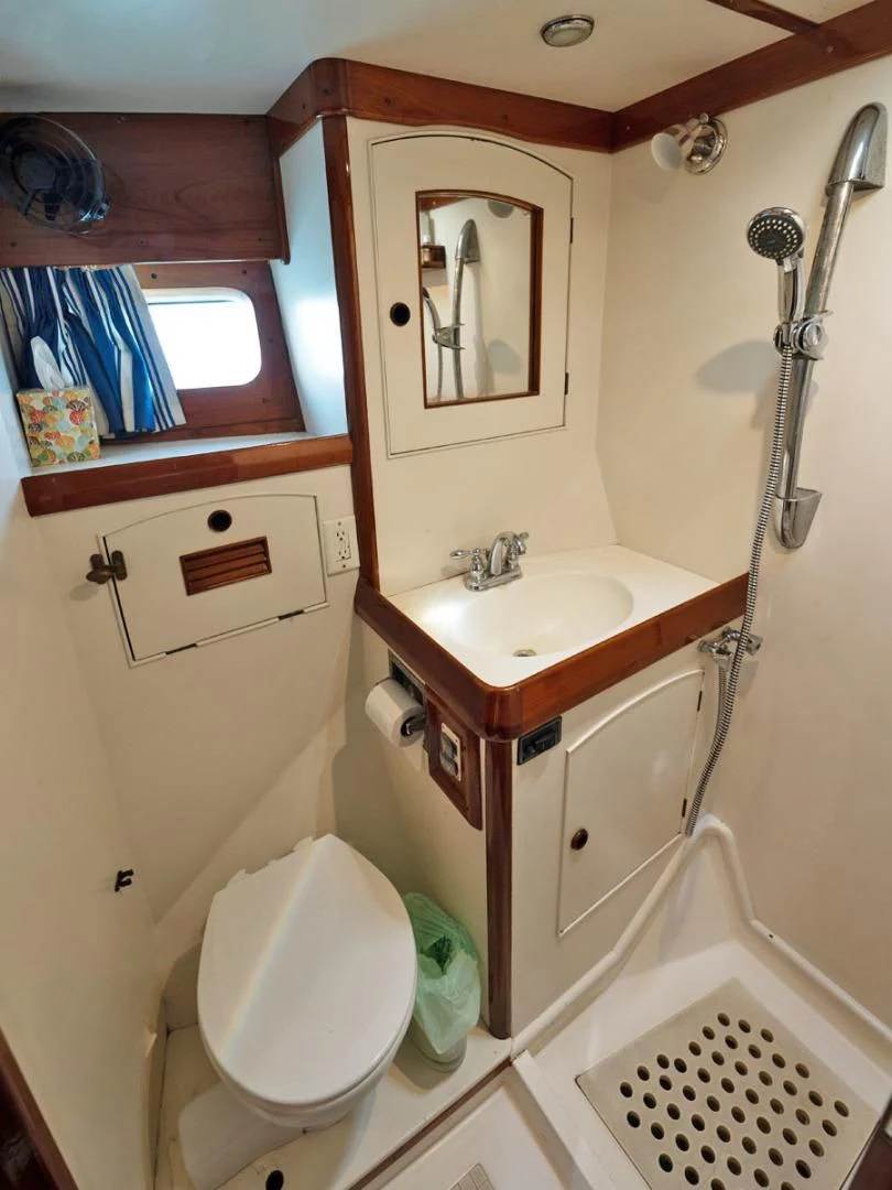a bathroom with a toilet and sink aboard HERMIE LOUISE Yacht for Sale