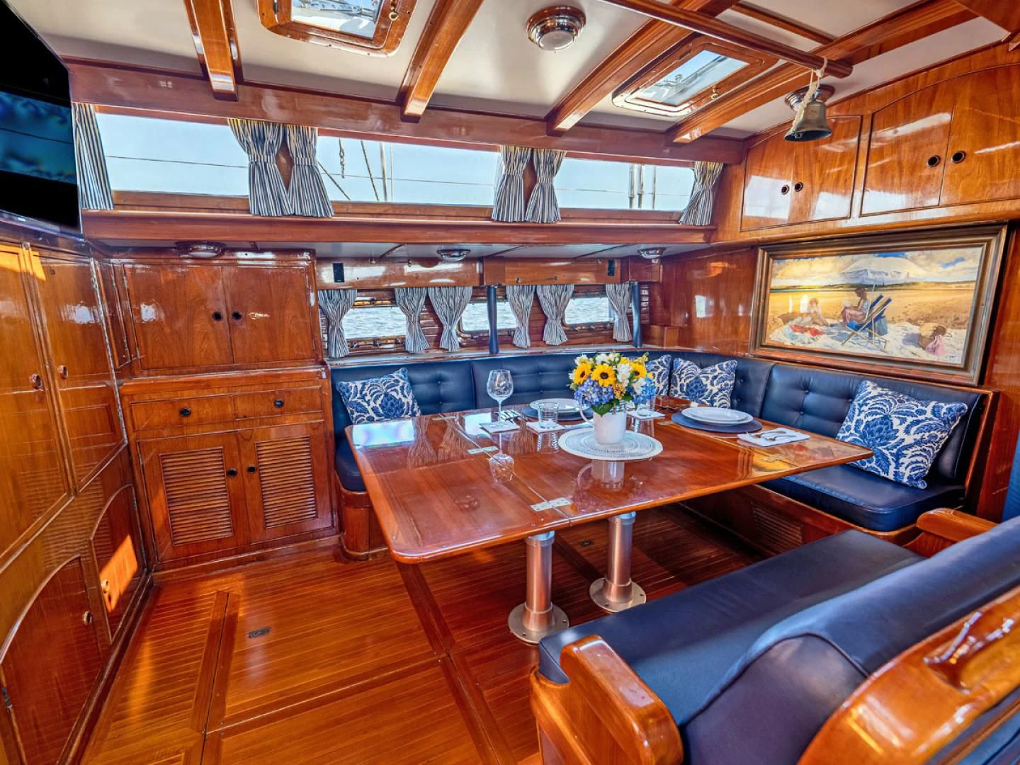 a room with a wood table and chairs aboard HERMIE LOUISE Yacht for Sale