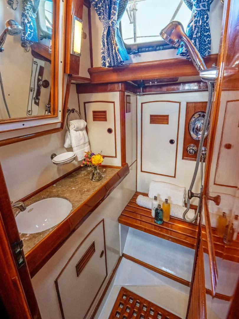 a bathroom with a sink and a mirror aboard HERMIE LOUISE Yacht for Sale