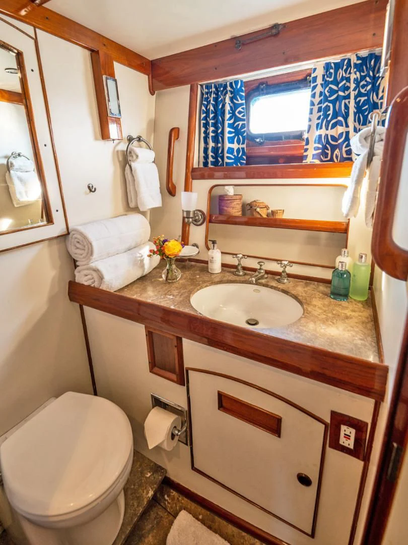 a bathroom with a sink and toilet aboard HERMIE LOUISE Yacht for Sale