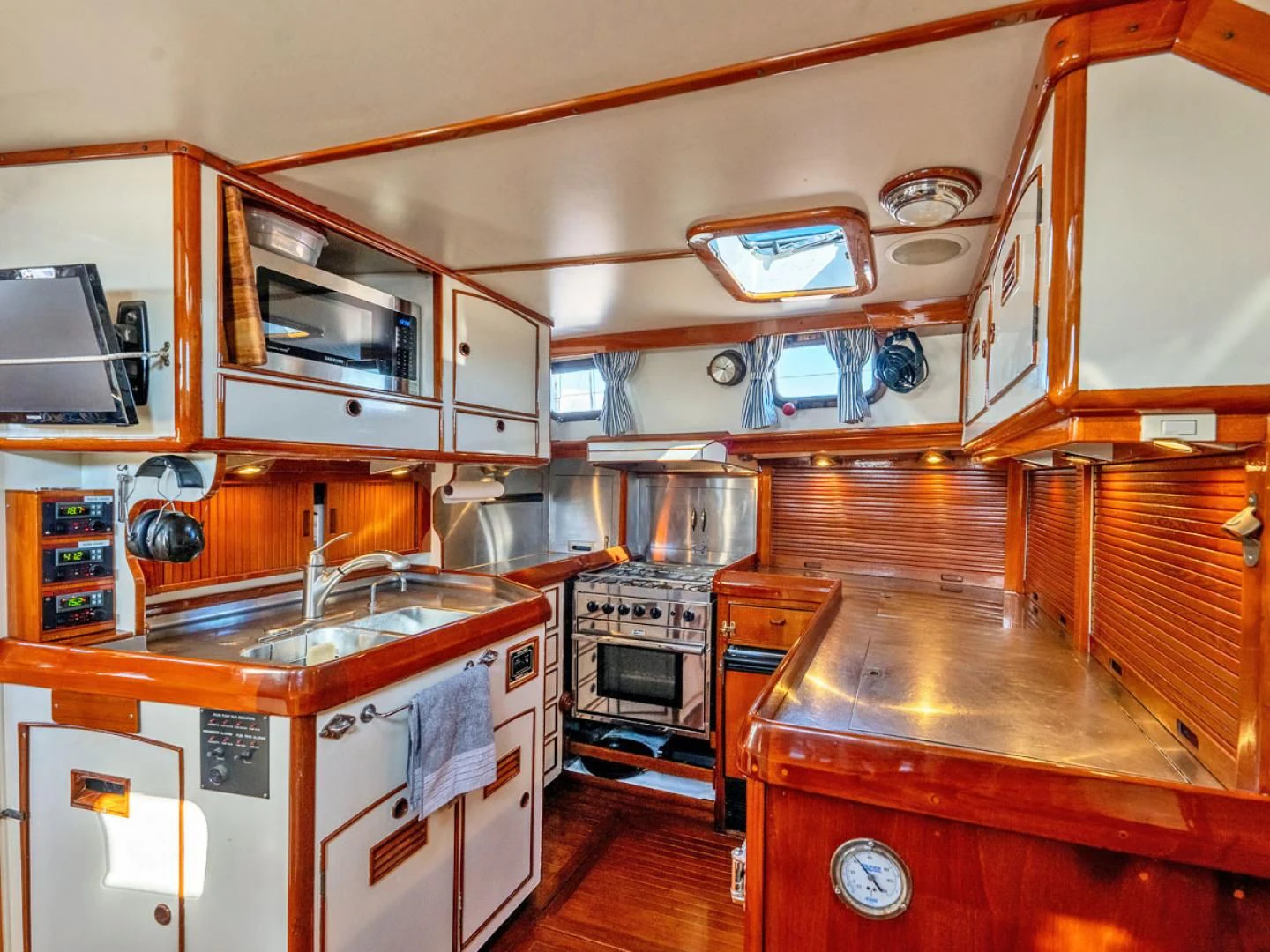 a kitchen with wooden cabinets aboard HERMIE LOUISE Yacht for Sale