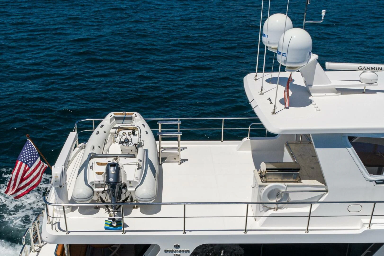 a boat with a flag on the front aboard KING OF NOTHING Yacht for Sale