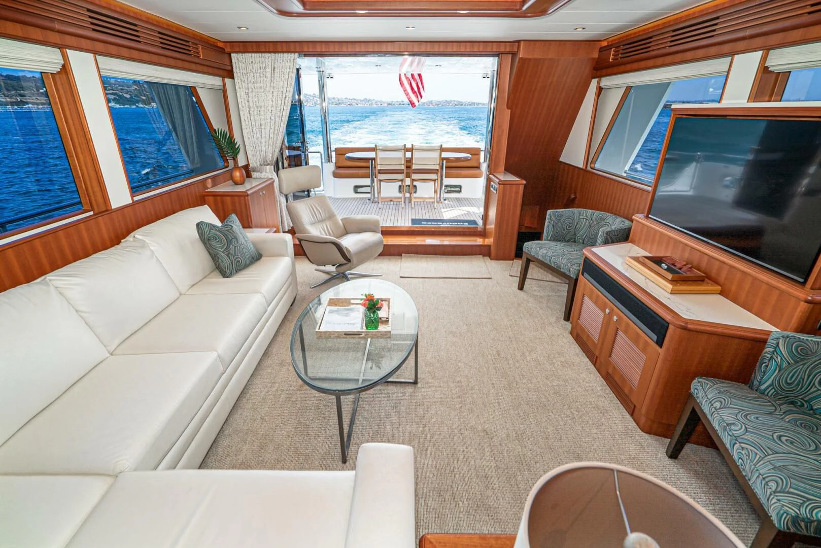 a living room with a couch and a television aboard KING OF NOTHING Yacht for Sale