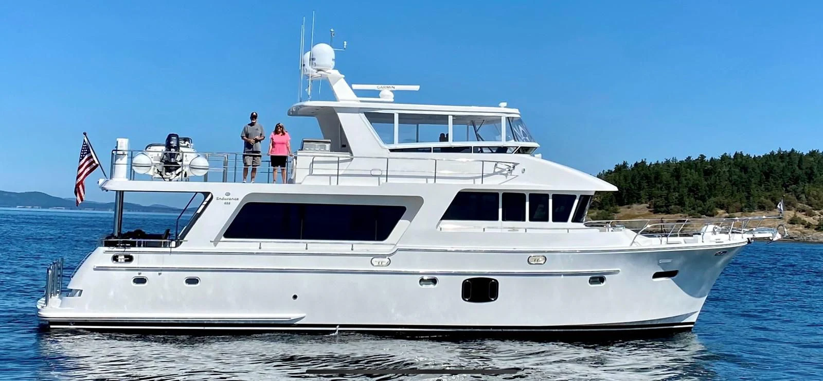 a white yacht with two people on it aboard KING OF NOTHING Yacht for Sale