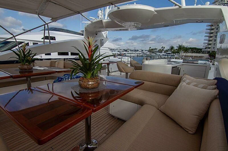 a room with a table and chairs aboard #OMG Yacht for Sale