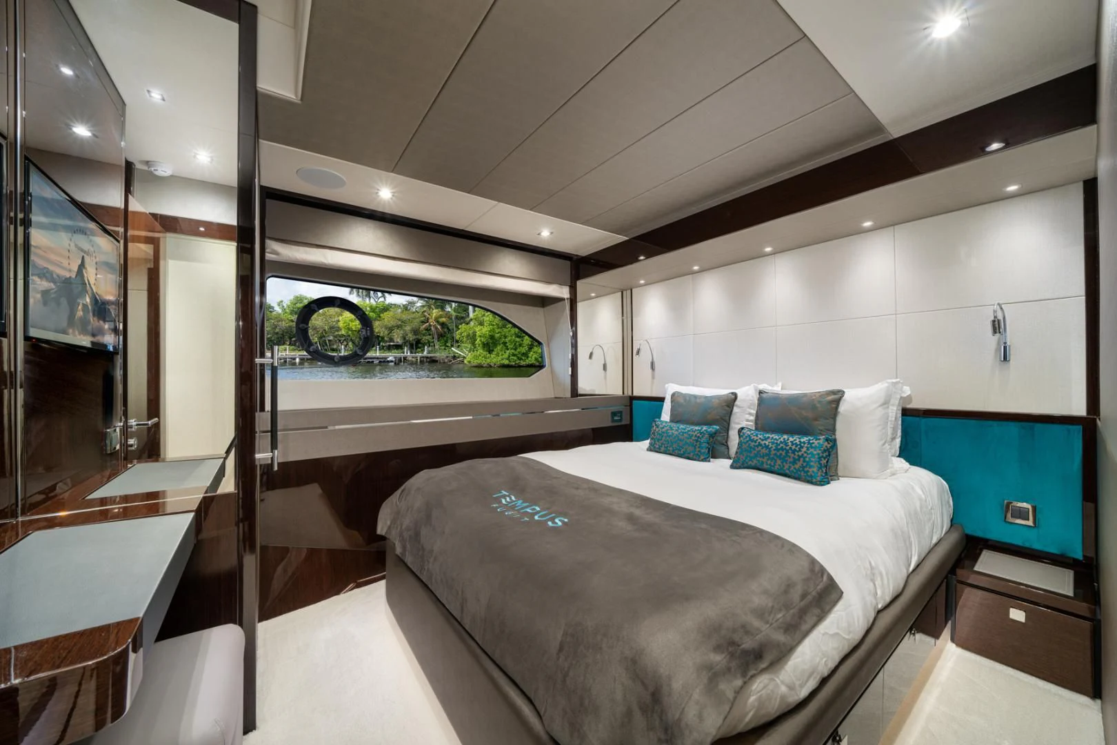 a room with a bed and a mirror aboard TEMPUS FUGIT Yacht for Sale