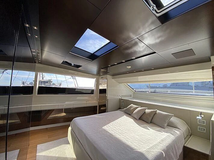 a room with a bed and a television aboard THE PHAT BOAT Yacht for Sale