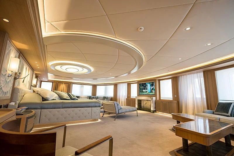 a large living room with a large chandelier aboard DREAM Yacht for Sale